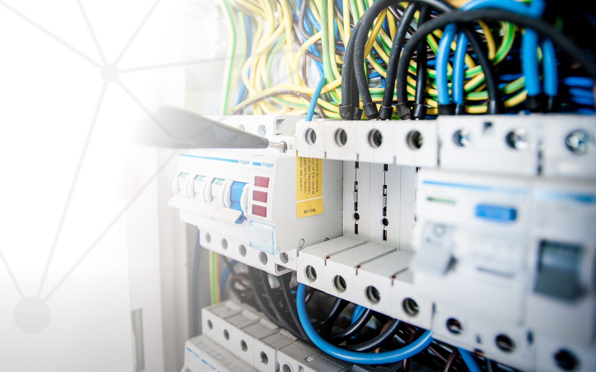 slider image. Person working at desktop with note pad and laptop